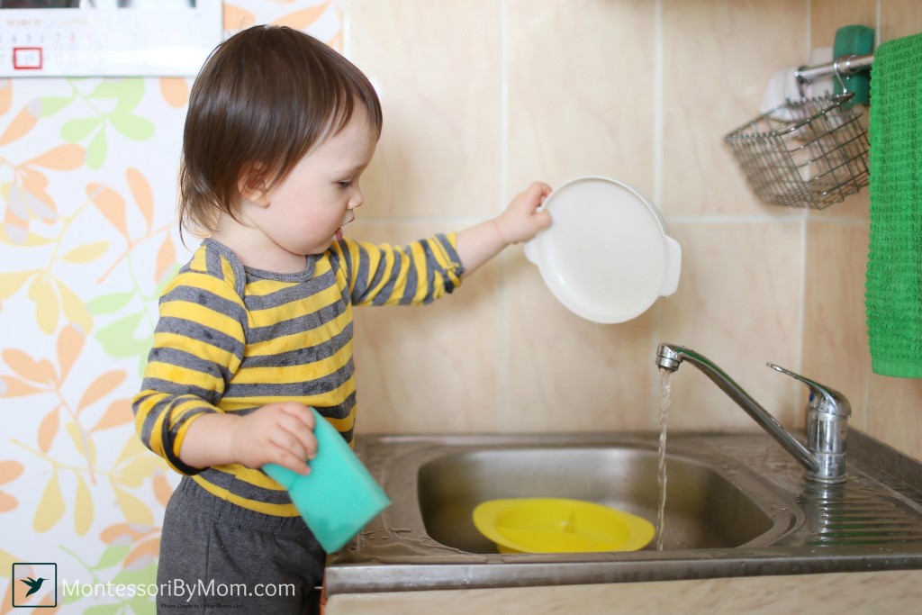 lovely 18 months baby washing dishes